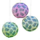 Tiki Tropics hanging lanterns featuring vibrant palm leaf prints, perfect for tropical decor and themed celebrations. Pack of 3.