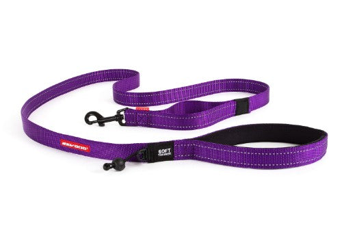 Vibrant purple EzyDog leash with soft webbing, reflective stitching, traffic handle, and waste bag lock for safe dog training.