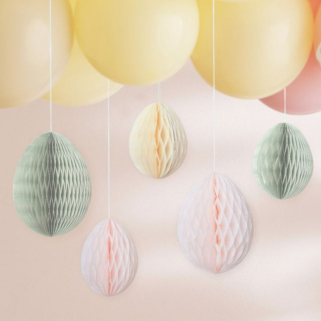 Colorful honeycomb Easter eggs in cream, light pink, and sage green for festive spring decor and easy hanging.