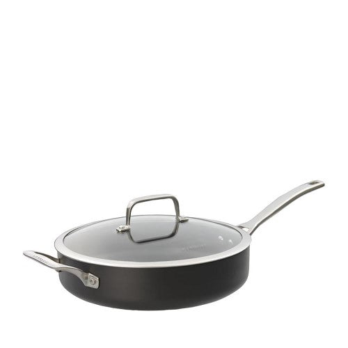 Durable 28cm induction-compatible saute pan with non-stick surface, helper handle, and tempered glass lid for versatile cooking.