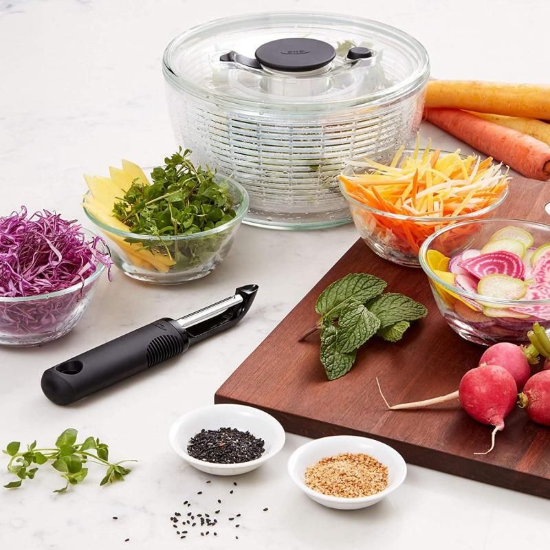 OXO Good Grips Swivel Peeler with twin stainless steel blades and ergonomic handle for effortless peeling of fruits and vegetables.