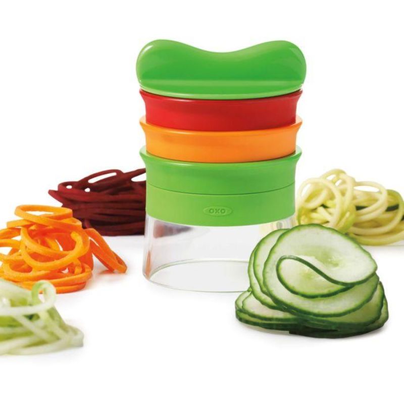 Hand-held spiralizer with three blades for creating healthy vegetable noodles, featuring a non-slip grip and food holder.