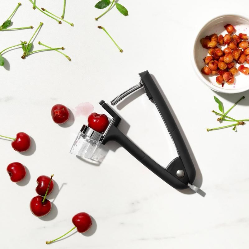 OXO Good Grips Cherry & Olive Pitter with removable splatter shield, durable design, and ergonomic non-slip handles.