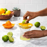 OXO Good Grips 2-In-1 Citrus Juicer with interchangeable reamers, measurement markings, and drip-free pour spout for easy use.