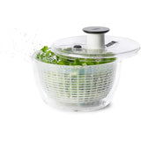 Compact OXO Good Grips Little Salad & Herb Spinner with one-handed pump, non-slip base, and multi-use colander design.