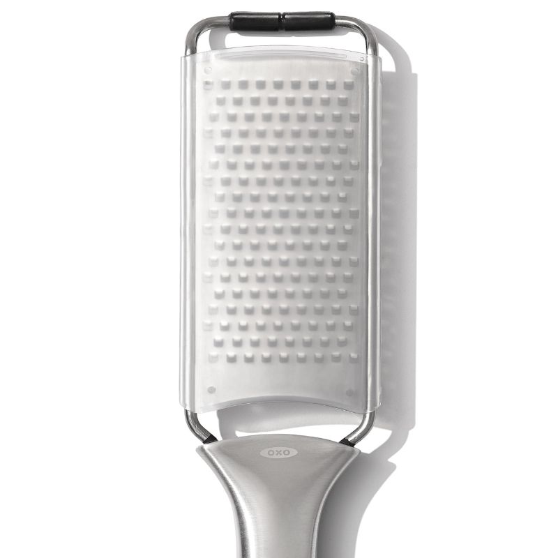 OXO Steel Medium Grater with sharp stainless steel teeth, ergonomic handle, and protective cover for safe storage.