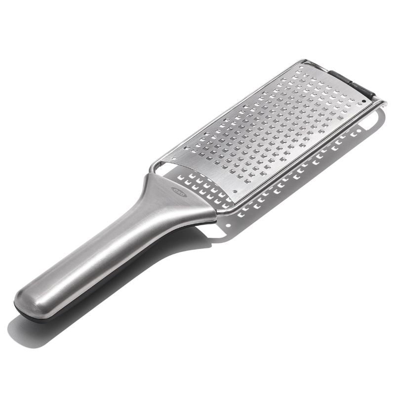 OXO Steel Medium Grater with sharp stainless steel teeth and ergonomic handle, perfect for grating cheese, veggies, and chocolate.