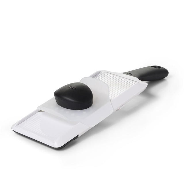 Hand-held mandoline slicer with adjustable thickness, soft-grip handle, and safety guard for precise fruit and vegetable slicing.