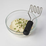 OXO Good Grips Wire Potato Masher with stainless steel head and cushioned handle for smooth, lump-free mashing.