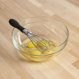 9-inch OXO Good Grip Whisk with ergonomic handle, stainless steel wires, perfect for mixing and aerating in small bowls.