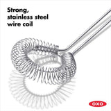 OXO Good Grips Sauce & Gravy Whisk with angled head, non-slip handle, and stainless steel for effortless whisking and mixing.