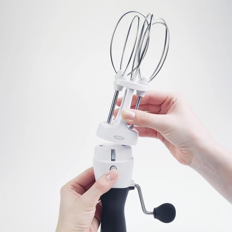 Compact OXO Good Grips Egg Beater Whisk with stainless steel beaters and ergonomic non-slip handle for effortless mixing.