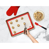 White OXO Good Grips Silicone Baking Mat, non-stick, reusable, fits half-sheet pans, oven-safe up to 450°F.