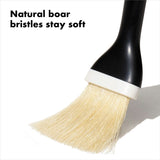 Natural boar bristle pastry brush with angled head, non-slip handle, perfect for basting and applying glazes. Dishwasher safe.