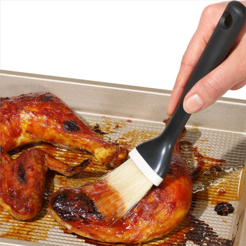 Natural boar bristle pastry brush with ergonomic grip and angled head for easy basting and glazing in baking.