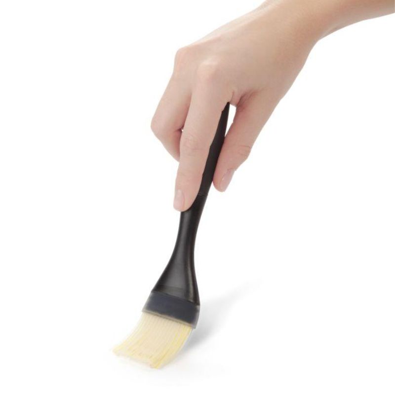 Silicone pastry brush with multi-layered bristles, heat resistant, and comfortable grip for applying sauces and glazes.