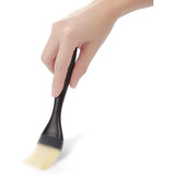 Silicone basting brush with heat resistance, tapered bristles, and easy-clean design for perfect sauce application.