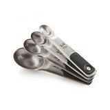 Set of OXO Good Grips stainless steel measuring spoons with magnetic handles, featuring etched markings for precise cooking measurements.