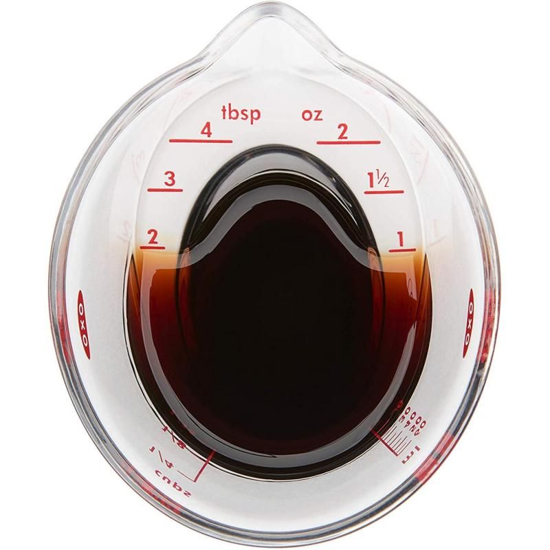 Mini angled measuring cup with easy-to-read markings for precise liquid and dry ingredient measurements in the kitchen.