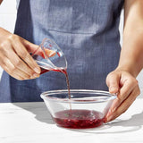 Compact mini measuring cup with angled surface for easy reading and precise measuring of liquids and dry ingredients.