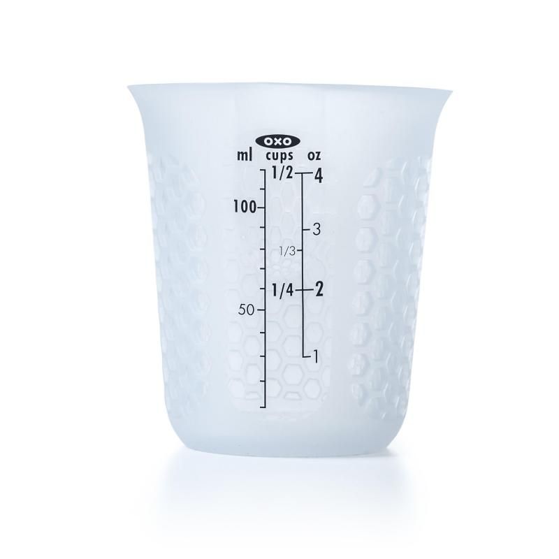 Compact silicone measuring cup with honeycomb pattern, flexible for easy pouring and microwave-safe for melting ingredients.