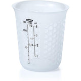 Silicone measuring cup with honeycomb pattern, easy squeeze spout, microwave-safe, and heat-resistant for precise pouring.