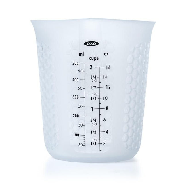 OXO Good Grip Squeeze & Pour Measuring Cup in silicone, features a narrow spout, measurement markings, and heat-dissipating grip.