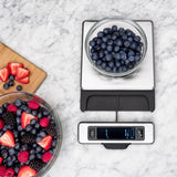 Stainless steel food scale with a pull-out display for precise measuring up to 11 lb/5 kg, ideal for cooking and baking.