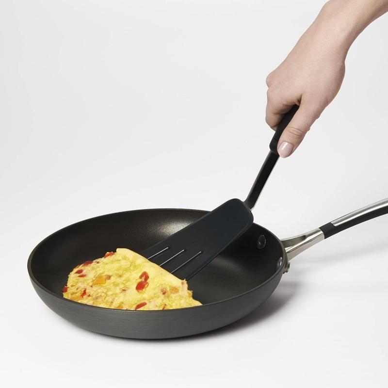 Silicone flexible omelette turner with stainless steel design for easy flipping of delicate foods without scratching cookware.