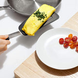 Silicone flexible omelette turner featuring a high-heat resistant head and non-slip grip for delicate food flipping.