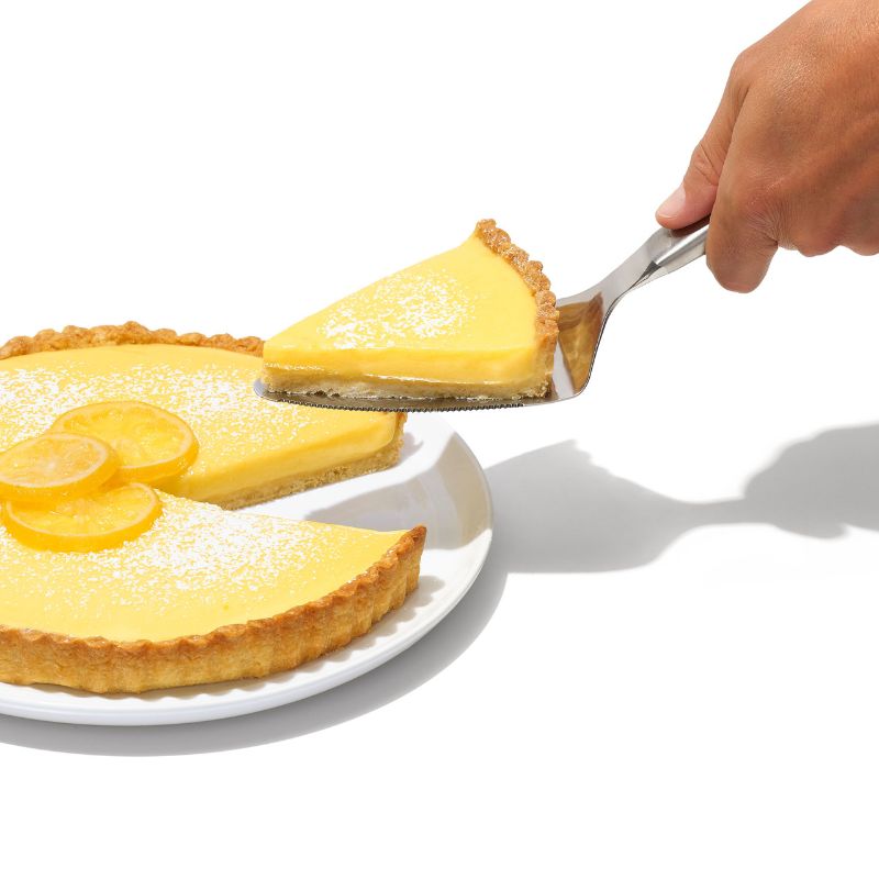 Sleek OXO Steel Pie Server with serrated edges and flexible head, perfect for effortlessly serving pies and desserts.