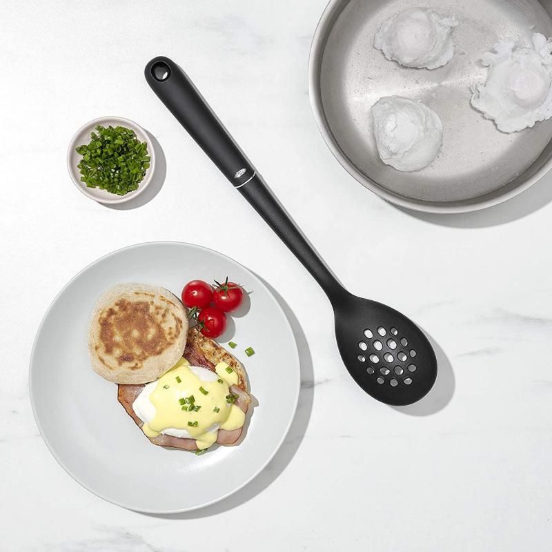 Nylon slotted spoon with a large head and soft grip, perfect for straining pasta and vegetables without scratching cookware.