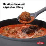 Versatile OXO Good Grips Silicone Spoon with non-slip handle, ideal for stirring and scraping non-stick cookware.