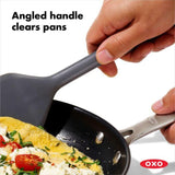 OXO Good Grips Silicone Turner with flexible beveled edges, heat-resistant silicone, and non-slip grip for easy food flipping.