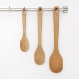 Three wooden cooking spoons in a set: large, medium, and small; crafted for durability and comfort in any kitchen.