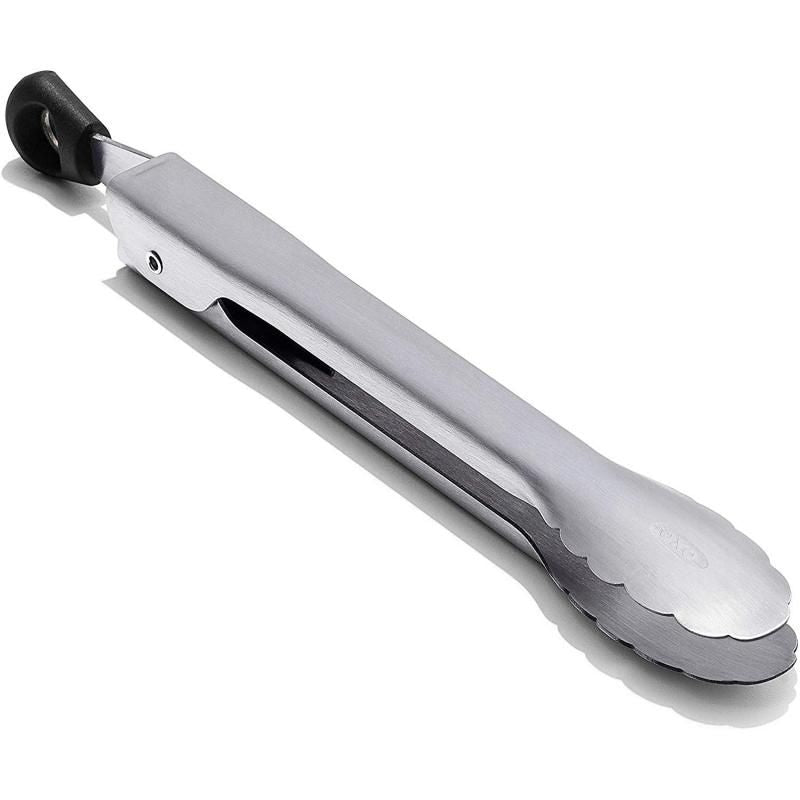 Compact stainless steel tongs with scalloped edges, ideal for serving appetizers and removing food from jars.