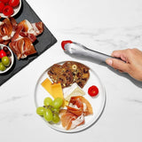 Compact stainless steel tongs with scalloped edges, ideal for serving appetizers and removing foods from jars.