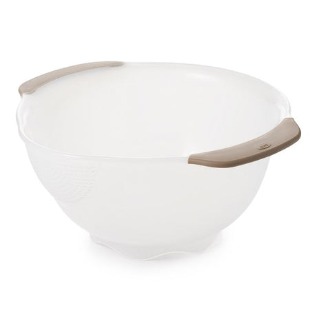 OXO Rice & Grain Washing Colander with small holes, pour spout, and non-slip handles for washing grains and berries effortlessly.