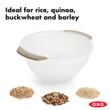 OXO Rice & Grain Washing Colander designed for easy washing of small grains with drainage holes and a pouring spout.