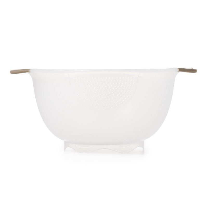 Compact OXO Rice & Grain Washing Colander with holes for perfect drainage, non-slip handles, and ideal for rinsing grains and berries.