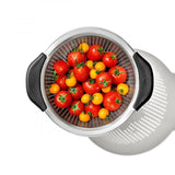 Stainless steel OXO colander with non-slip handles, ideal for rinsing and straining foods comfortably and efficiently.