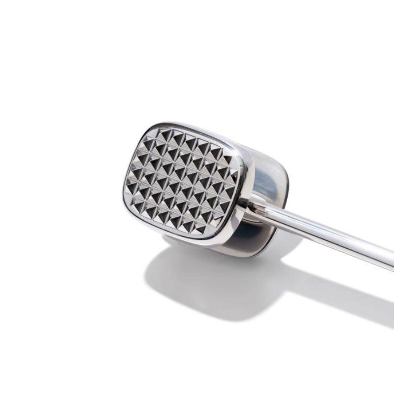 Image of OXO Good Grips Die Cast Meat Tenderizer with ergonomic non-slip handle, featuring pyramid teeth and smooth side for meat preparation.