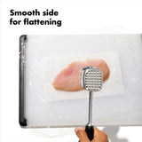 Die-cast aluminum meat tenderizer with ergonomic grip and dual sides for tenderizing and flattening meat efficiently.