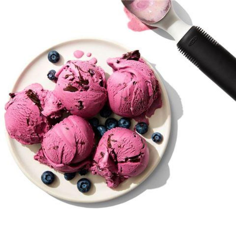 Ergonomic stainless steel ice cream scoop with pointed tip, non-slip grip, and flat edges for easy serving and cleanup.