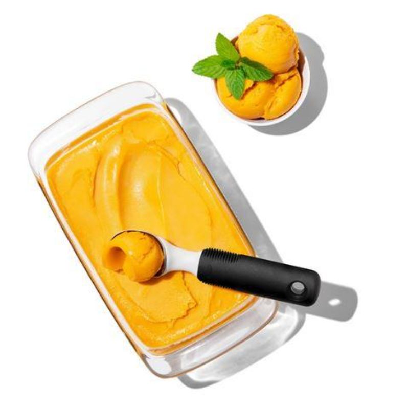 Ergonomic ice cream scoop with pointed tip and flat edges, designed for easy serving and minimal waste.