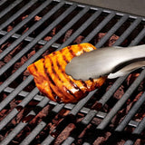 Stainless steel grilling tongs with non-slip grip, angled head, and scalloped edges for safe, precise food handling.