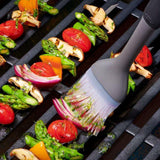 OXO Good Grips Grilling Basting Brush with silicone bristles, long handle, and angled head for mess-free sauce application.