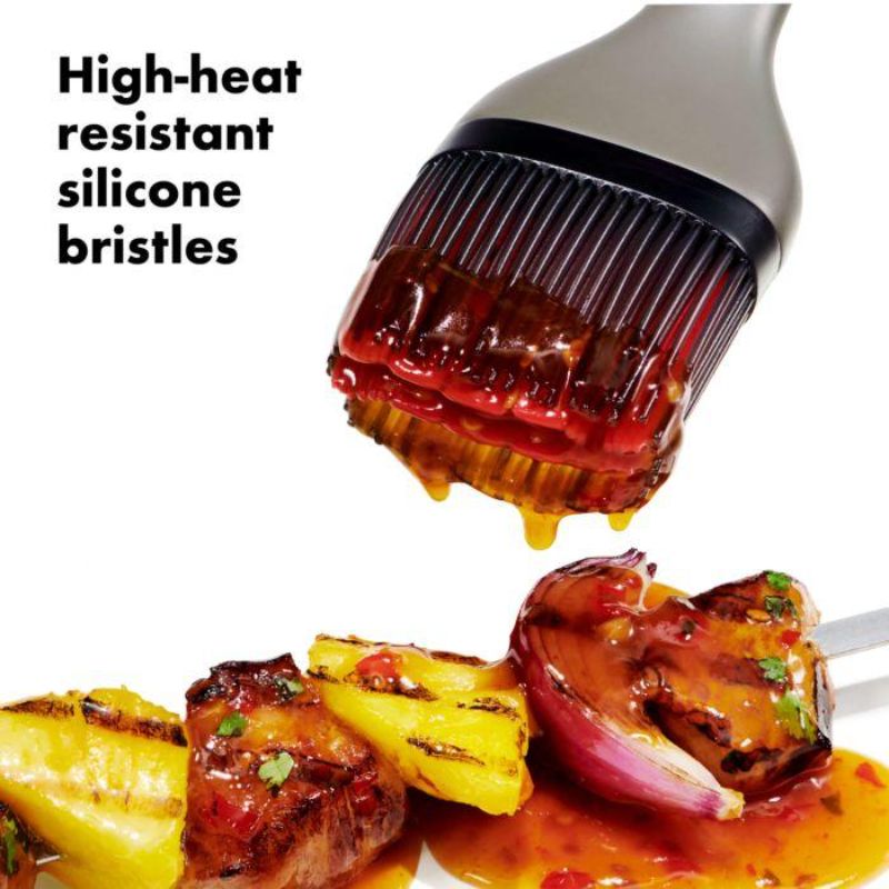 OXO Good Grips Grilling Basting Brush with heat-safe silicone bristles and long handle for mess-free basting and grilling.