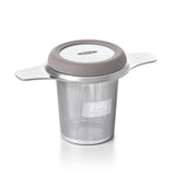 Stainless steel tea infuser basket with silicone grips for brewing loose leaf tea, featuring a dual-function lid.