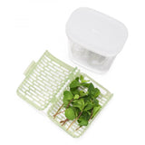 Compact herb keeper with moisture control for fresh herbs like basil and cilantro, featuring 360° air circulation.